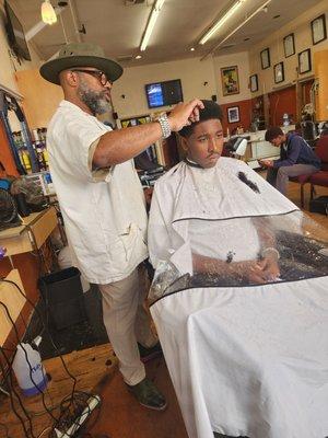 Trevor uses the shears to shape my son's hair to perfection while giving great advice on how to navigate young adulthood.