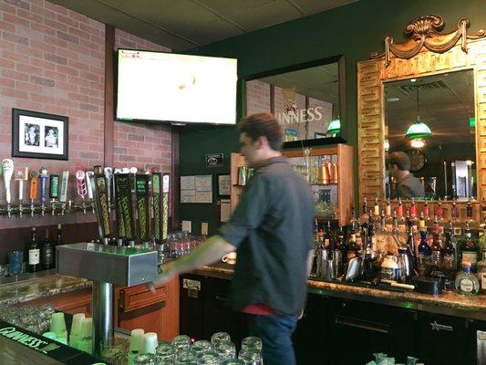 Man U game on the TV and Rob lost behind the bar.