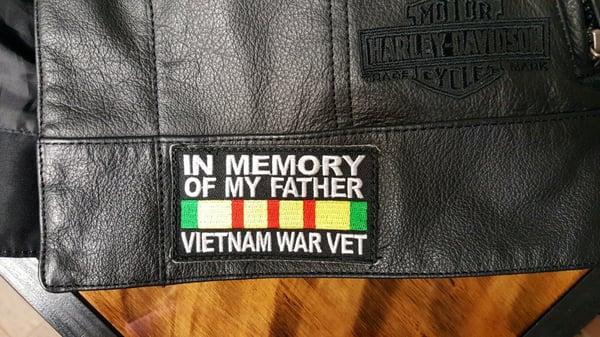 Memorial patch sewn on leather, crooked.