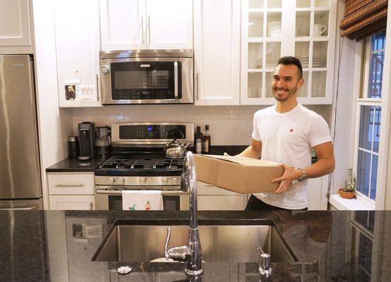 Albert, the business owner, unpacking and organizing a kitchen!