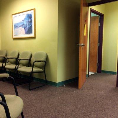 Waiting area, with one of two entrances into the treatment area. Everything is very clean and minimal.