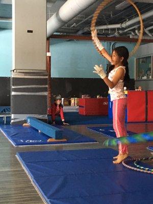 One of our summer camp students plays with the gym equipment.