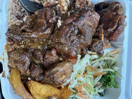 Stew chicken dinner with rice cabbage and plantains