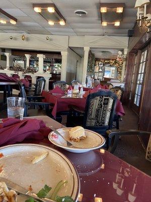 Dining room, the remains of a chicken Parmesan sandwich and a salad, with a view of the patio. Looks great to try in warmer weather!