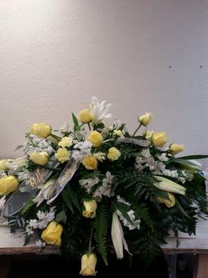 Casket spray. Any color roses with lilies.