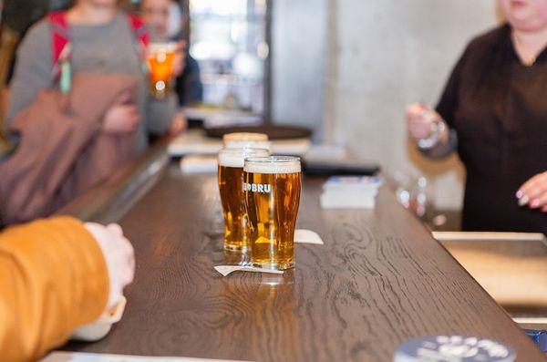 A group of people enjoying drinks at SLU BRU bar.