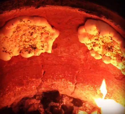 Garlic Naan made to order in the tandoor oven using fresh charcoal everyday!!