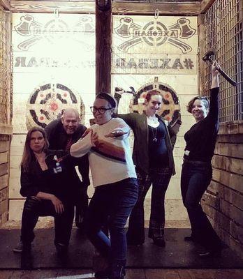 Feeling victorious at the end of our axe throwing game.