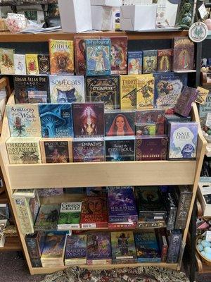 We carry hundreds of different tarot and oracle decks, these are near the  counter, many more are by the books.