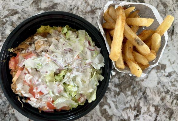 Chicken bowl with white sauce and a large fries