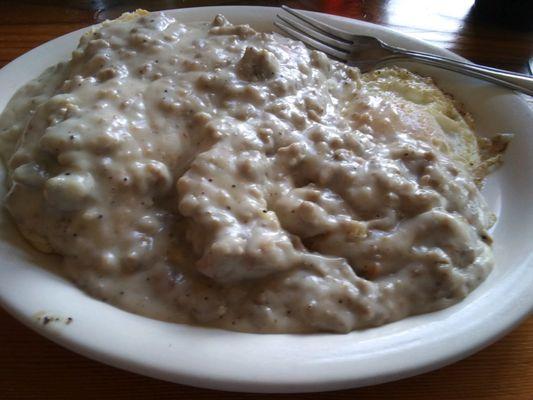 Biscuits & Gravy burying 2 over-medium eggs.