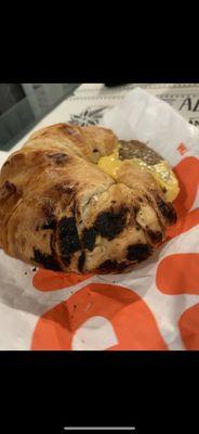 A burnt sausage and egg croissant