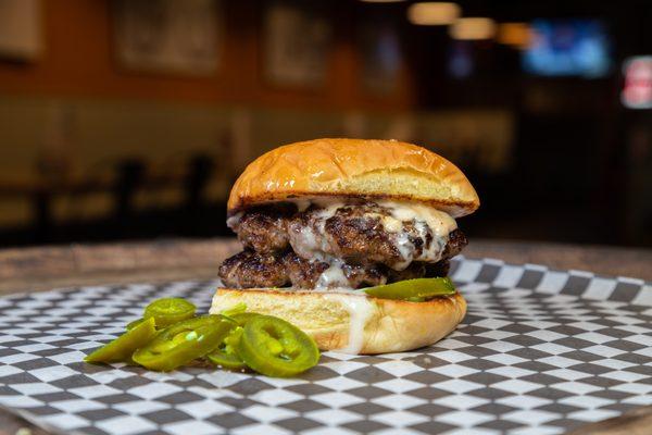 The Queso Blanco - Two American Wagyu beef patties, queso dip, jalapeños, chipotle aioli