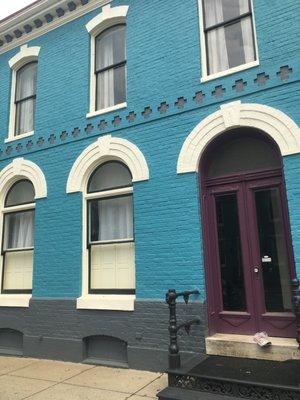 Enter through the front, purple door and proceed down the hallway to the treatment room.