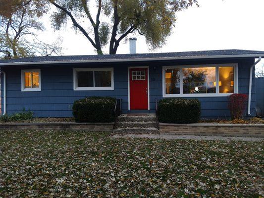 We painted the cedar siding with Sherwin Williams Rejunivation, sprayed the gutters/windows white and the door red for that pop of color.