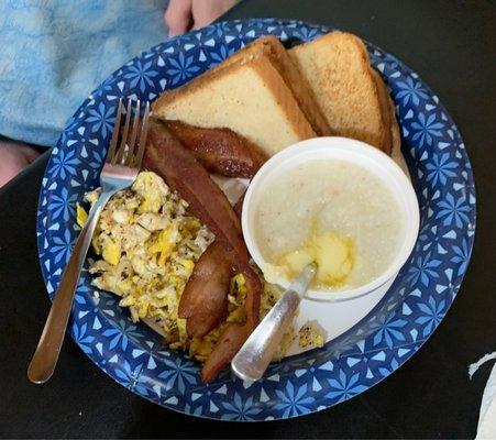 Eggs, toast, grits, and bacon