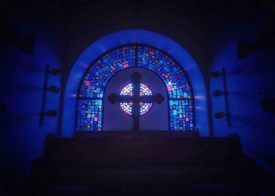 Stained glass window in the choir loft at sunset