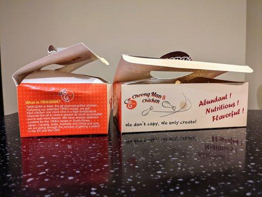 Side view of Choong Man Chicken's fried chicken boxes.