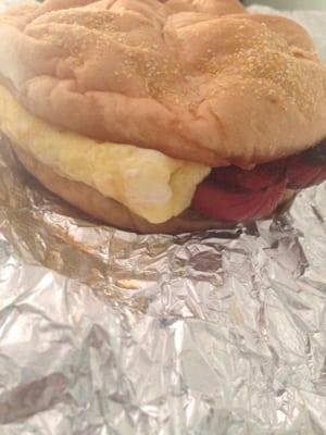 Hot sausage, egg, and cheese on a kaiser roll