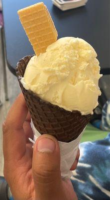 Vanilla ice cream in a chocolate waffle cone