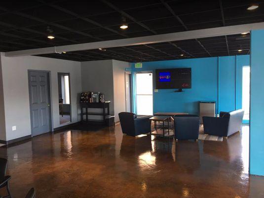 Clean waiting area with complementary coffee and water