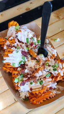 Loaded Sweet Potato Waffle Fries: Sweet potato waffle fries, buttermilk dressing, Cotija cheese, bacon, scallions.