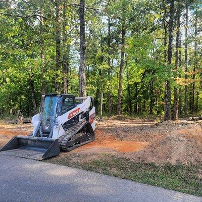 T86 cutting grade for an 18-wheeler trailer to sit on, complete with ramp, for upcoming home construction.