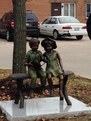 children reading statues