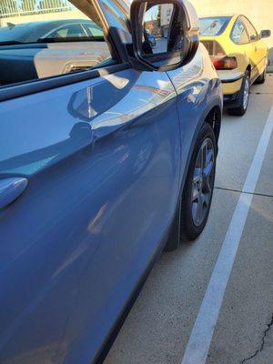 My neighbor dented and scratched my front passenger door.