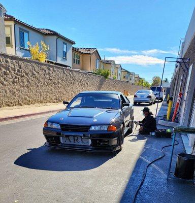 Son working on a customers car