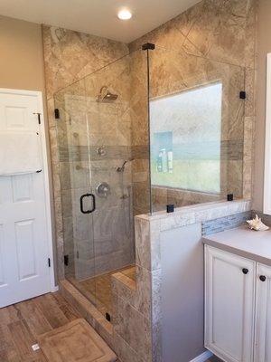 On this shower we used Emser tile and a frameless glass shower. We also added a seat in the shower for sitting.