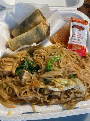 Noodle box with two beef noodle egg rolls