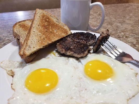 The daily breakfast special: 2 eggs, hand-pattied sausage, and 2 slices of wheat toast, with a coffee. Reasonably priced, and delicious!