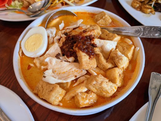 Laksa with chicken. Udon noodles, tofu, bean sprouts, and egg in coconut-spiced soup. $14.95.