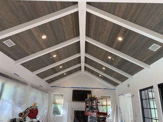 Custom exposed beams and planking installed on a cathedral ceiling