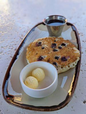 Child pancake with blueberries.