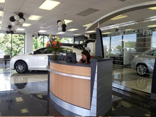 Suntrup Buick GMC's receptionist area and showroom.