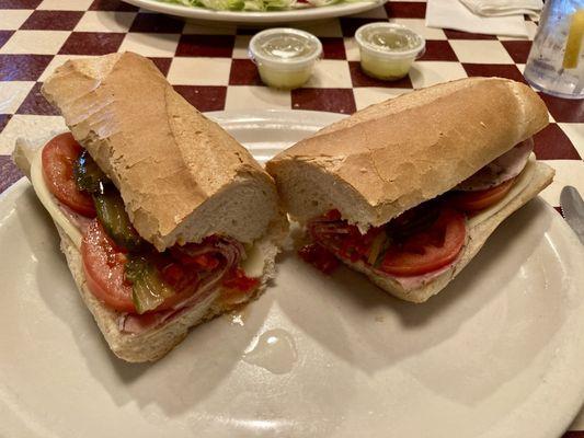 Italian Cold Cut Sub with Genoa salami, sweet capicola, thinly sliced provolone w/tomato, hots, pickles and oil.