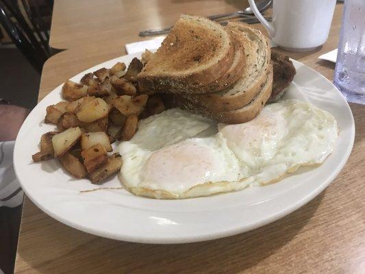 Eggs over medium, sausage, and rye bread