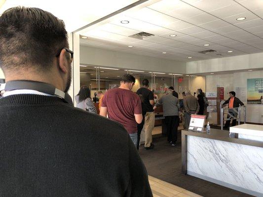 The line is out the door once again, Friday afternoon and two tellers???