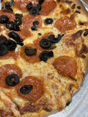 Two topping pizza with pepperoni and black olives