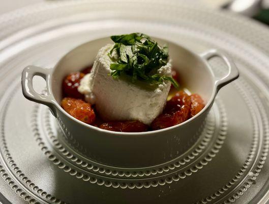 Home made ricotta on a bed of roasted cherry tomatoes