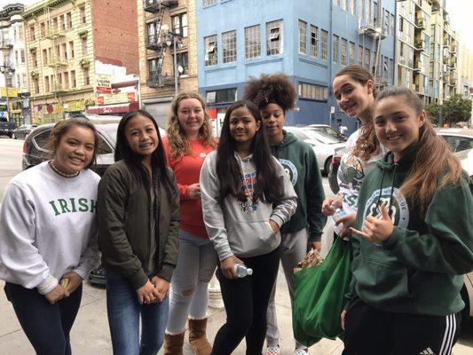 Some girls of the Sacred Heart Cathedral Basketball team coming back after making then distributing bags of food on a  Saturday morning.