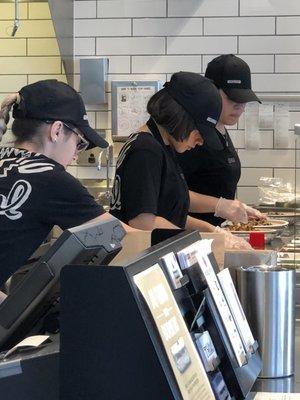 The ladies and cooks work hard trying to get the line moving.