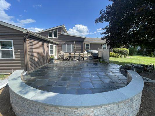 Techo Bloc seat wall with PA Flagstone caps around patio extension in State College, PA