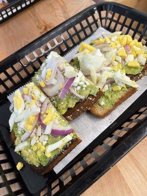 Protein toast with avocado, boiled egg, red onions and feta