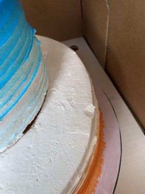 Fingerprints on the side of the cake.