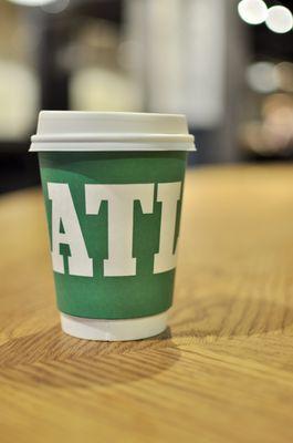 hot drinks cup holding an americano