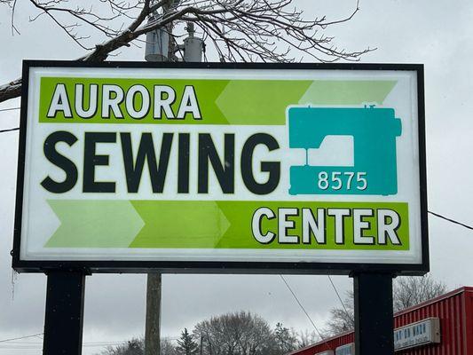 front Aurora Sewing Center sign on Main Street