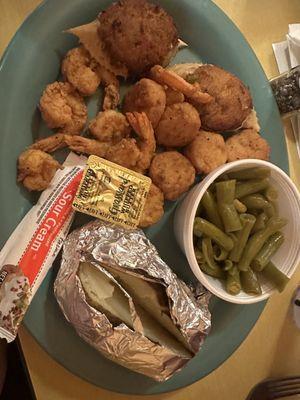 Crab cakes, shrimp and scallops with green beans and baked potato